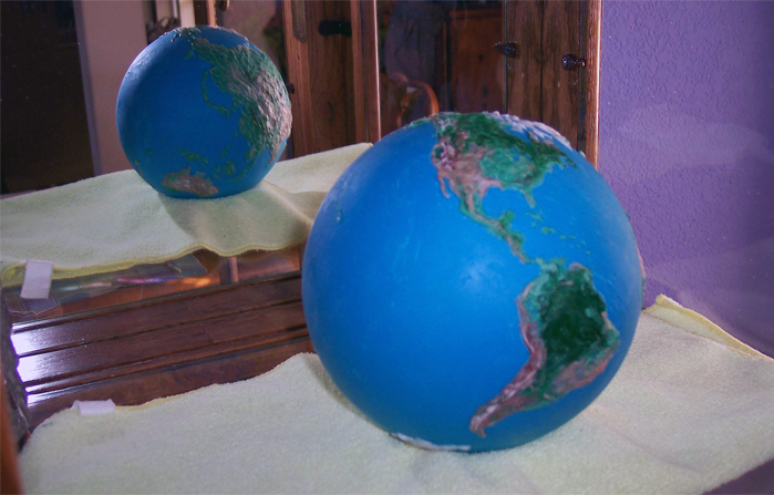 The globe for the desk cake was hollow and all edible, made with colored candy melts and completely accurate geographically. Tempered chocolate was considered for this piece, but it would not have held up under the heat at the County Fair. (7/2010)